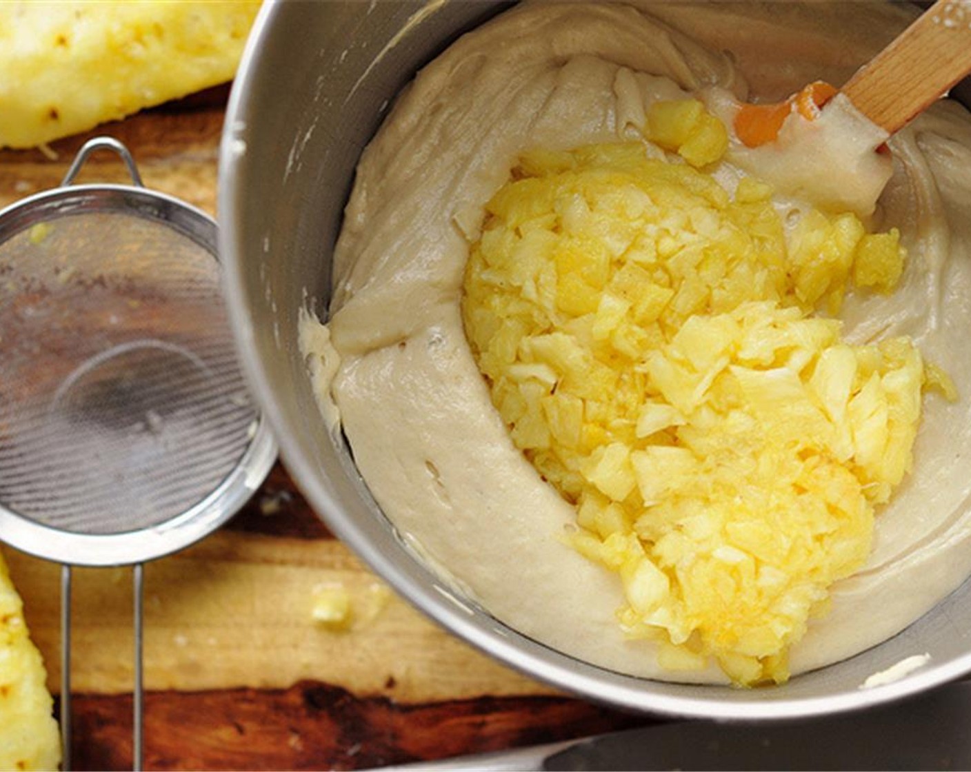 step 10 Fold in the Pineapple (1/2 cup). Using a medium ice cream scoop, scoop out the batter into the prepared mini bundt pan. Rap the pan on the counter a few times to release any air bubbles lodged in the batter.