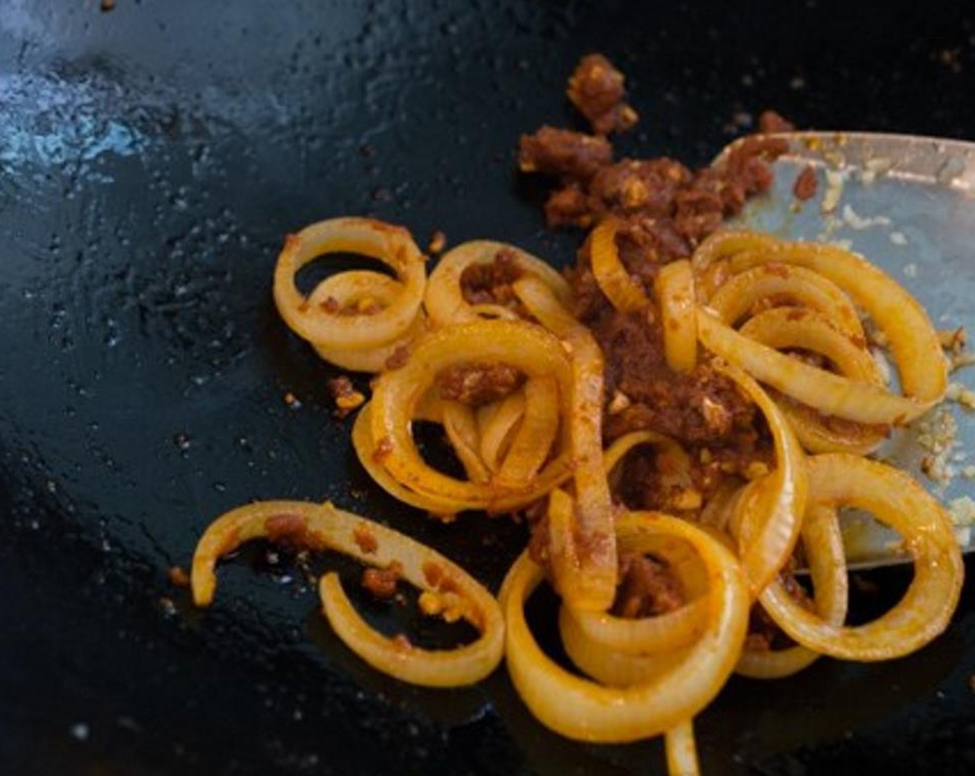 step 2 As soon as the onions start to turn translucent, add the Thai Red Curry Paste (2 Tbsp) and saute the curry for a few seconds.