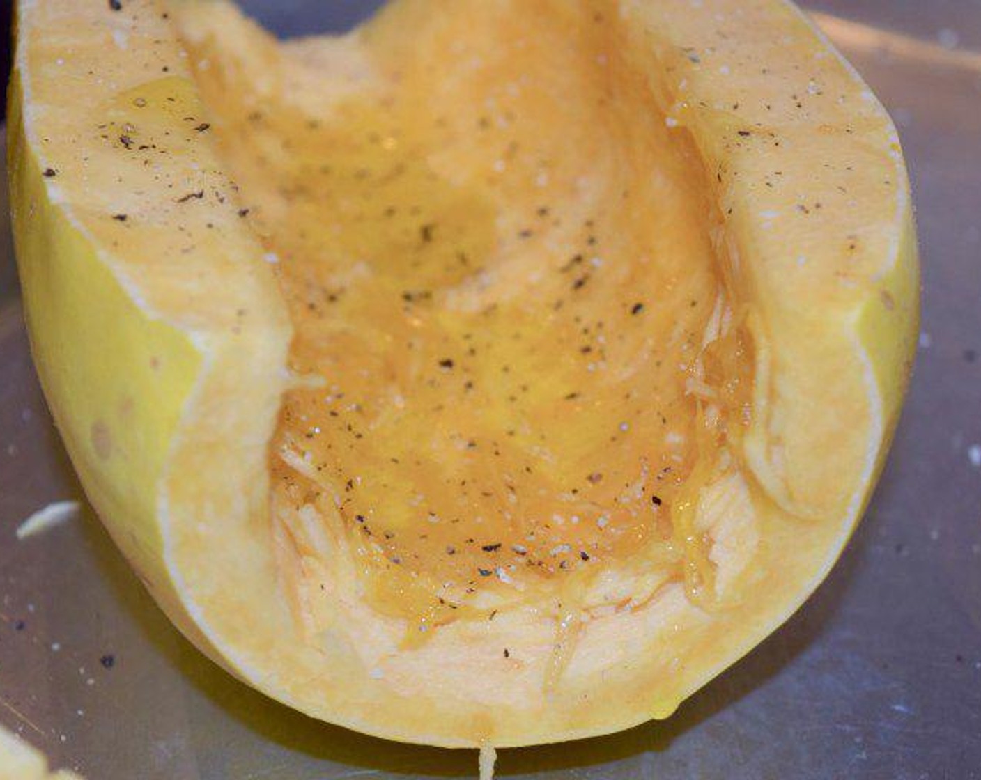 step 3 With a spoon, remove the seeds from each half. Drizzle each half with Extra-Virgin Olive Oil (1 Tbsp) and season with Salt (1/4 tsp) and Ground Black Pepper (1/2 Tbsp). Place squash face side down on a baking sheet and cook for 45 minutes, or until fork tender.