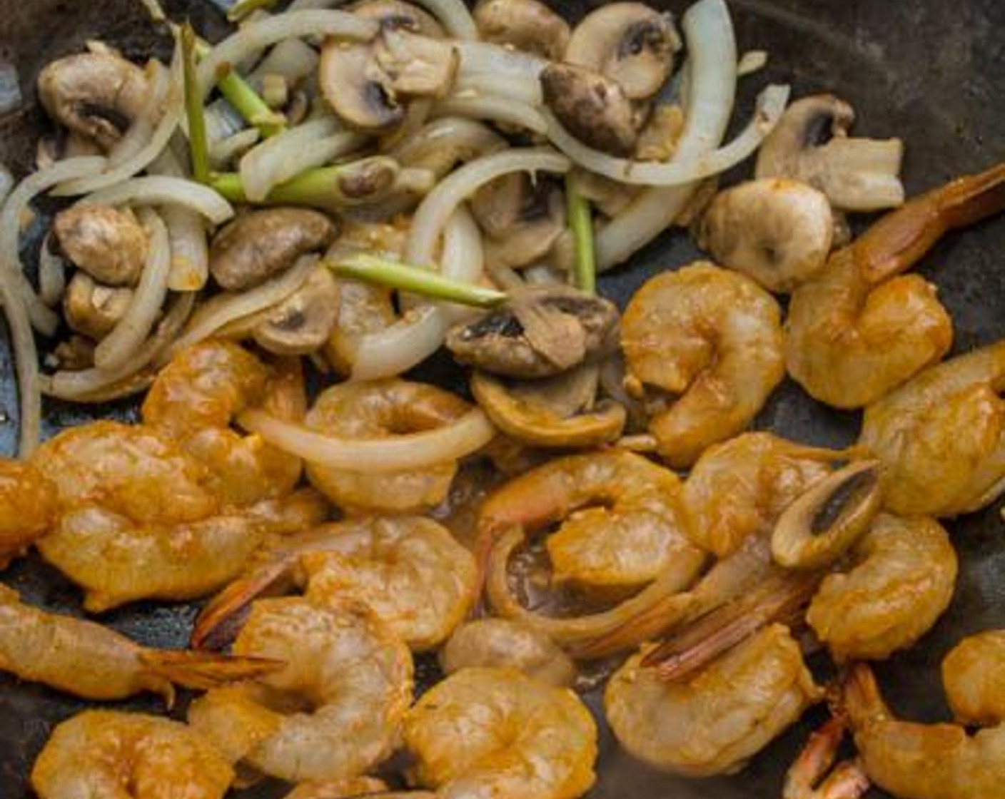 step 7 Push all the ingredients to the side of the wok, making way for the shrimp. Add the shrimp to the wok in one single layer. Leave the shrimp untouched for about 30 seconds to allow them to sear.