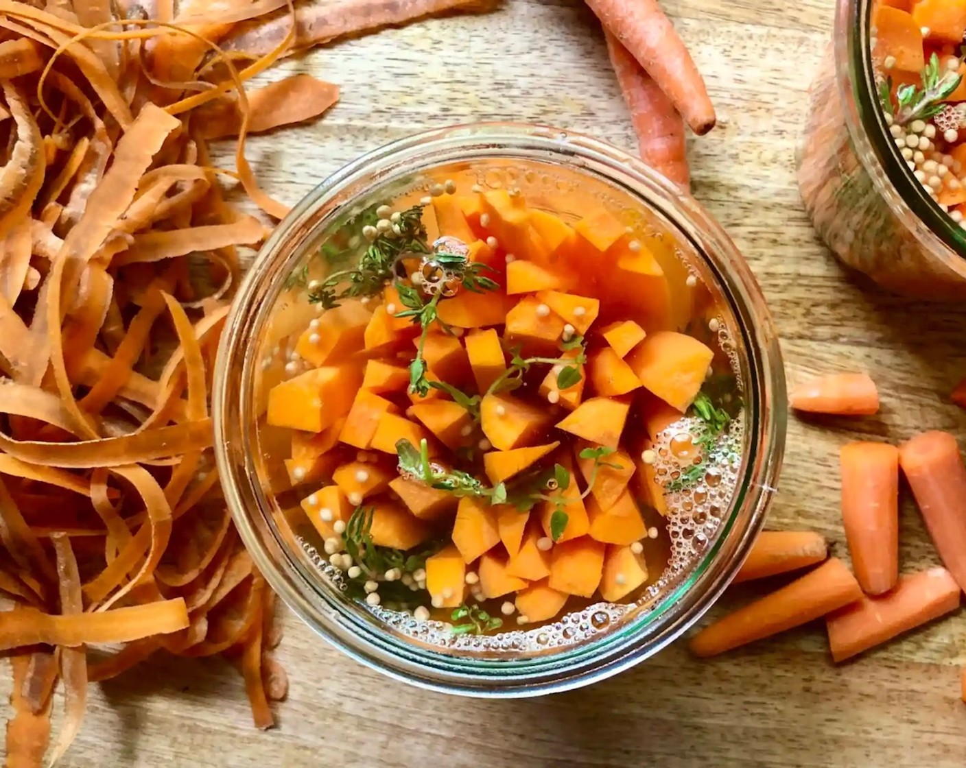 step 4 Pour the hot brine over the carrots in each jar, being sure to completely immerse them in the liquid.