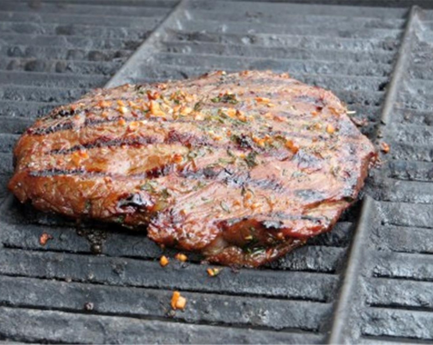 step 5 Heat barbecue or grill to medium high heat. Remove steak from marinade, and blot off the excess moisture with a paper towel. Place steak on the hot grill. Cook for 5-6 minutes on the first side for medium rare. Flip and cook an additional 5-6 minutes.