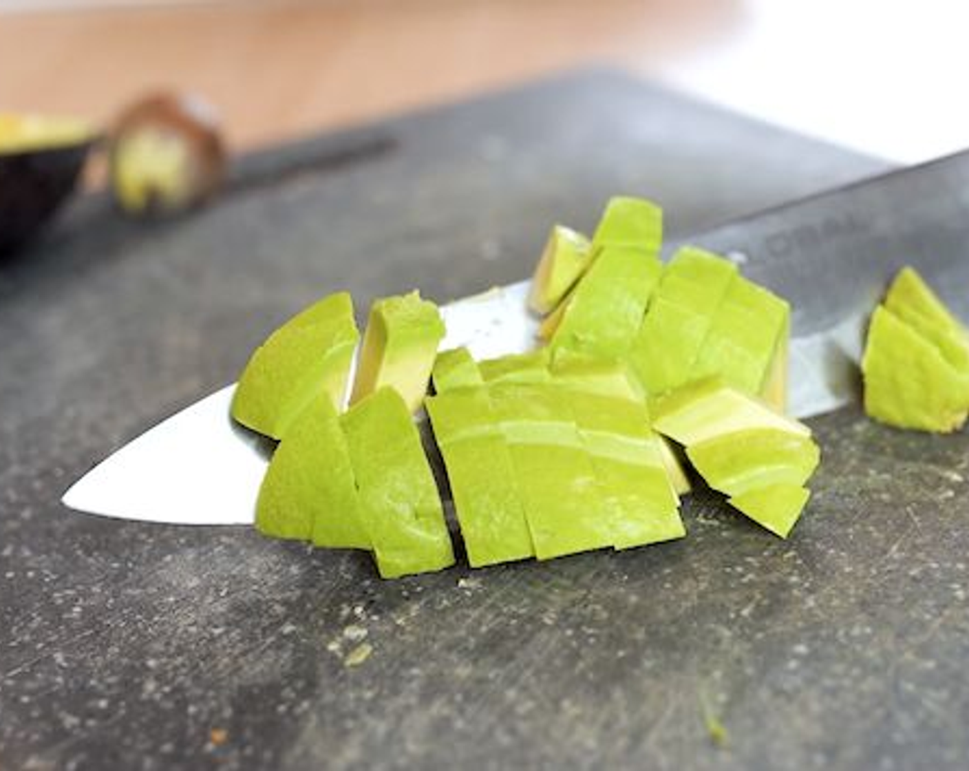 step 9 Halve the Avocados (2) then quarter and peel the skin. Dice 1 avocado and cut the other into slices.