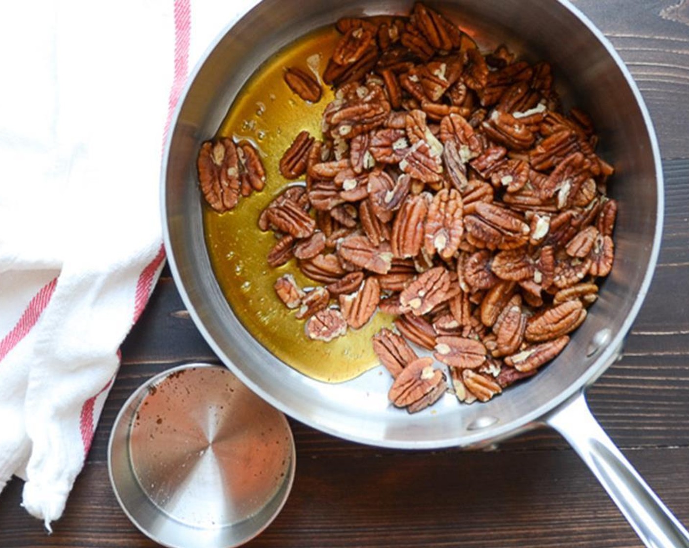 step 1 Lay a piece of parchment paper on a baking sheet. Add Pecans (2 cups), Honey (2 Tbsp), Maple Syrup (2 Tbsp), Cayenne Pepper (1 dash), and Salt (1/4 tsp) into a heavy, medium-sized saucepan.