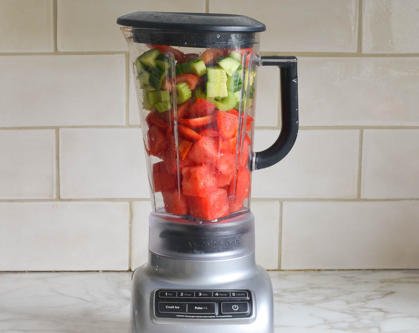 step 8 Put the Watermelon, Celery, Tomato, English Cucumber, Bell Pepper, Ginger, Red Chili Pepper (1/2), Fresh Basil Leaf (1 handful), Juice of Limes (2), Salt (1/2 tsp), and Ground Black Pepper (1/4 tsp) into a blender.