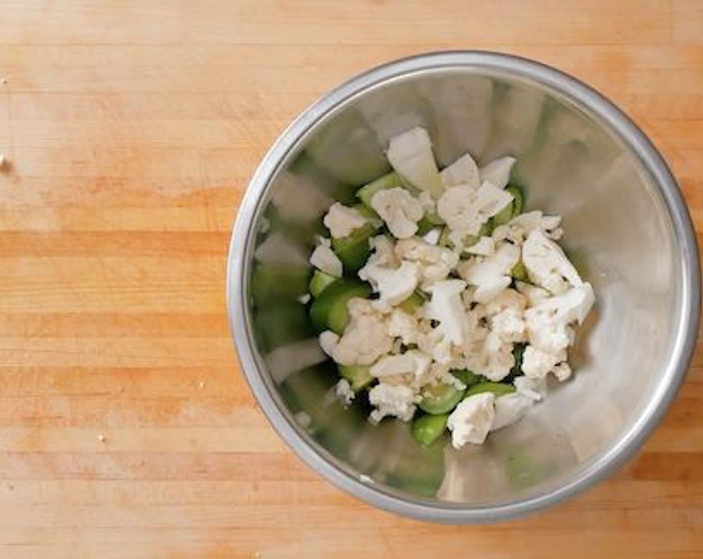 step 1 Medium dice the Cauliflower (1), Tomatillos (4), and Brussels Sprouts (5) into bite-sized pieces. Tear the Brussel sprouts apart and place into a bowl.