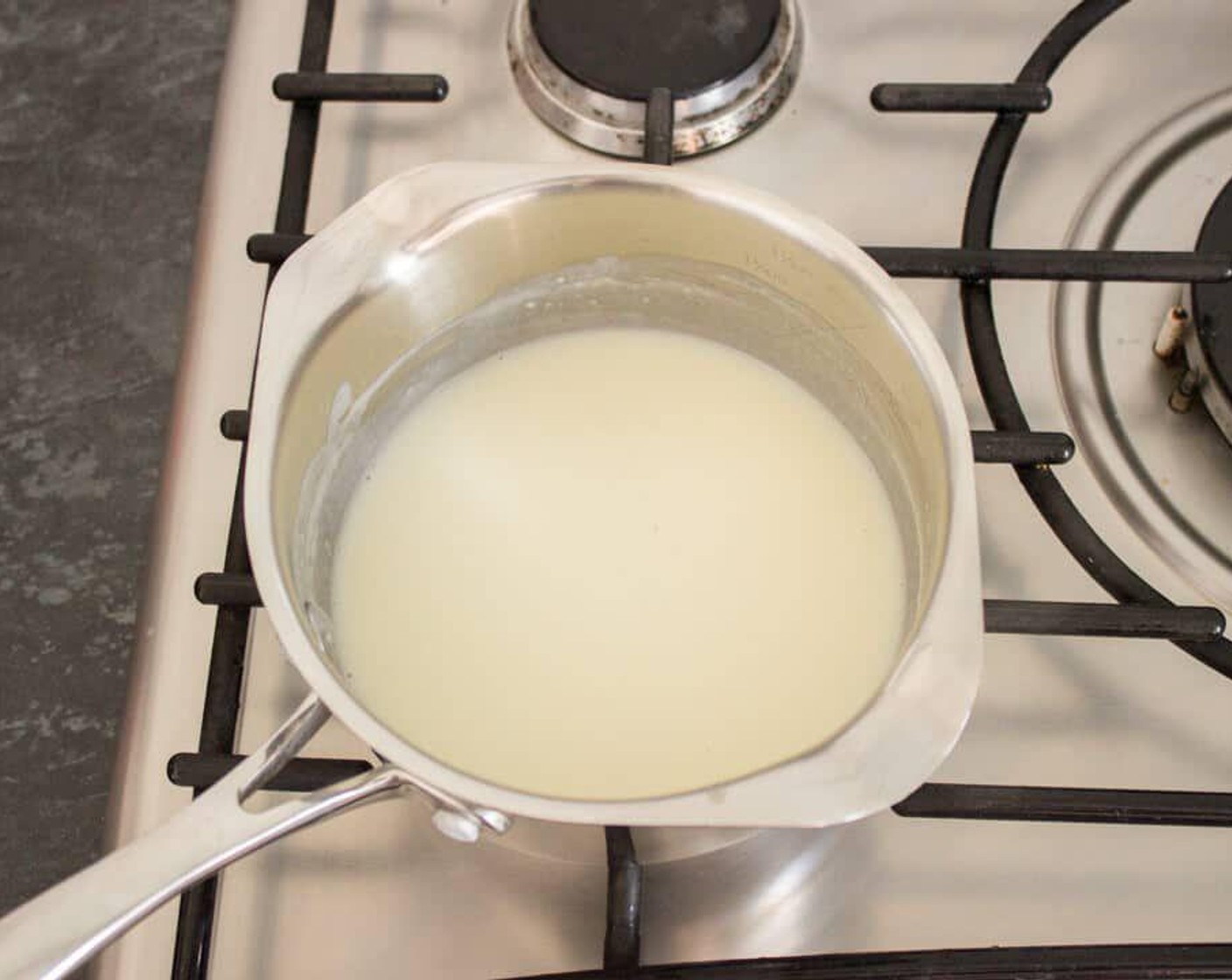step 4 Gradually add in the 2% Reduced Fat Milk (1/3 cup) bit by bit, stirring constantly and fairly vigorously to smooth out any lumps. When the milk is all used up, you should end up with a slightly thick white sauce.