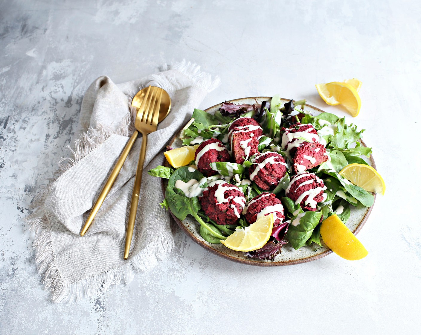 step 5 Spread out Salad Mix (as needed) on a platter, add the falafel balls and drizzle with the lemony tahini sauce.