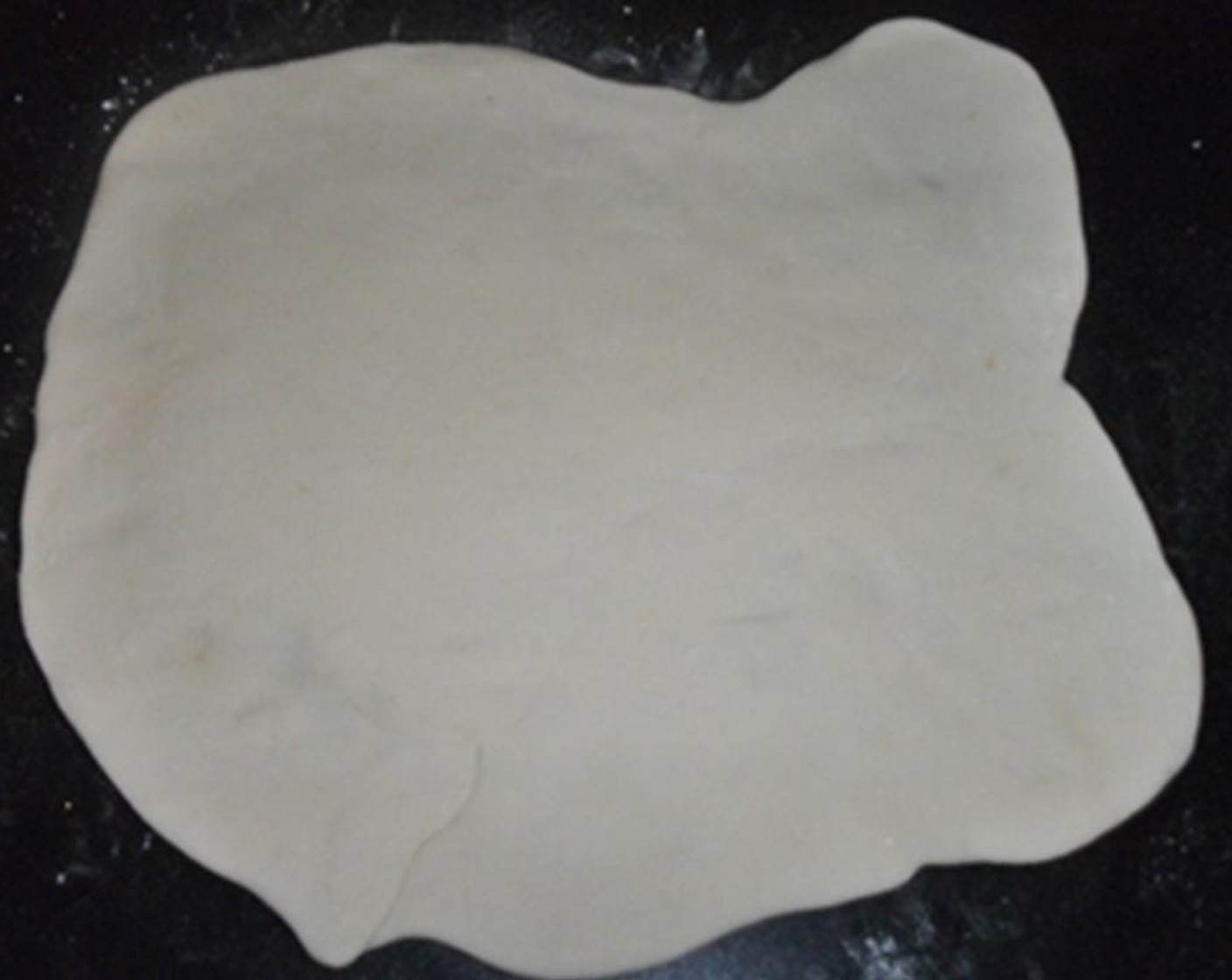 step 5 Using your hands or a rolling pin, stretch out the dough into a thin sheet.