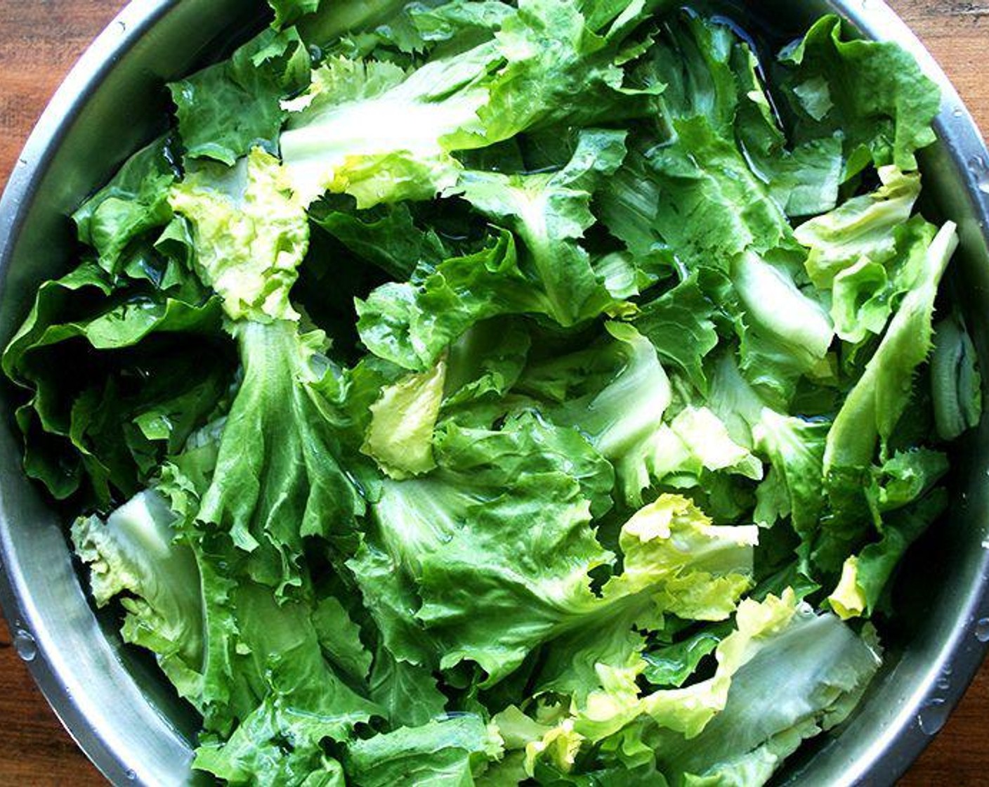 step 2 Cut the core end of the Escarole Lettuce (5 2/3 cups) off and place the leaves in a large bowl filled with cold water. Let sit for at least 5 minutes.