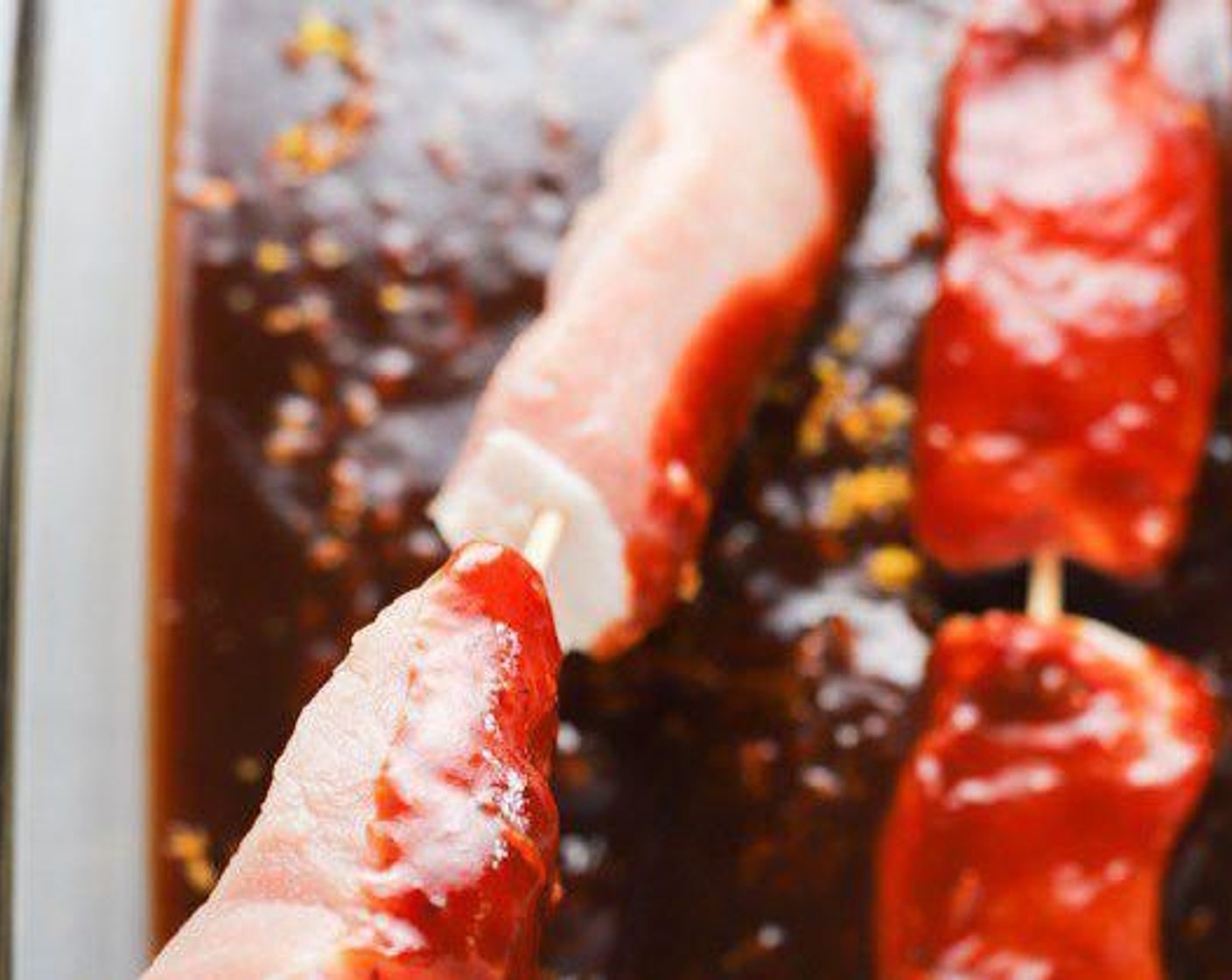 step 2 Cut Boneless Pork Chops (2 lb) into long strips. Put 2-3 pieces on wooden skewers lengthwise. Place each pork skewer into the sauce mix and spin them to coat all sides. Cover the dish with plastic wrap and marinate in the refrigerator for 3-6 hours, or overnight.