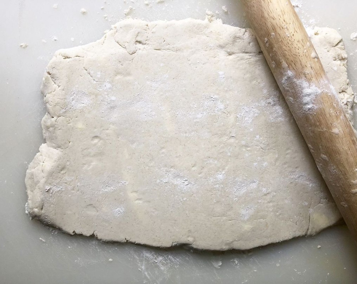 step 4 Begin to shape the dough. Turn out the dough onto a lightly floured surface. Sprinkle the top lightly with more flour, and roll out into a rough rectangle that is about 1-inch thick.