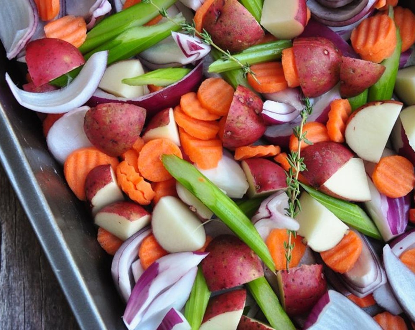 step 6 Spread Celery (3 stalks), Carrot (1 cup), Red Onion (1), Red Potatoes (3 cups) at the bottom of a 9x13-inch pan.
