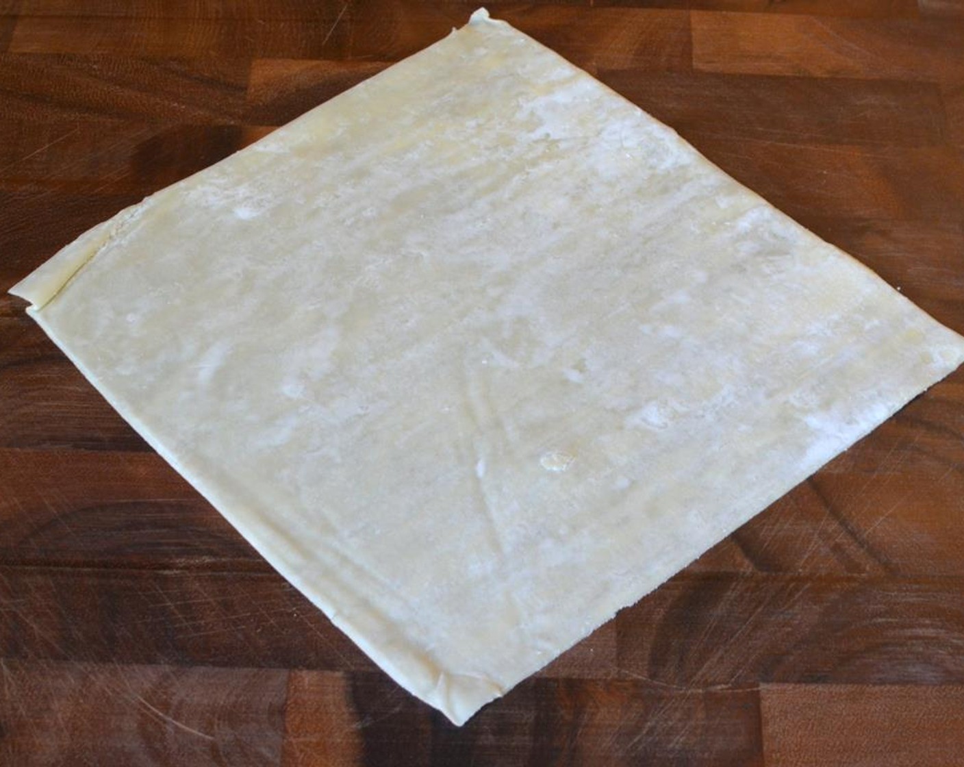 step 7 Prepare the Spring Roll Wrappers (6) by placing wrapper on a cutting board diagonally so it looks like a diamond shape.