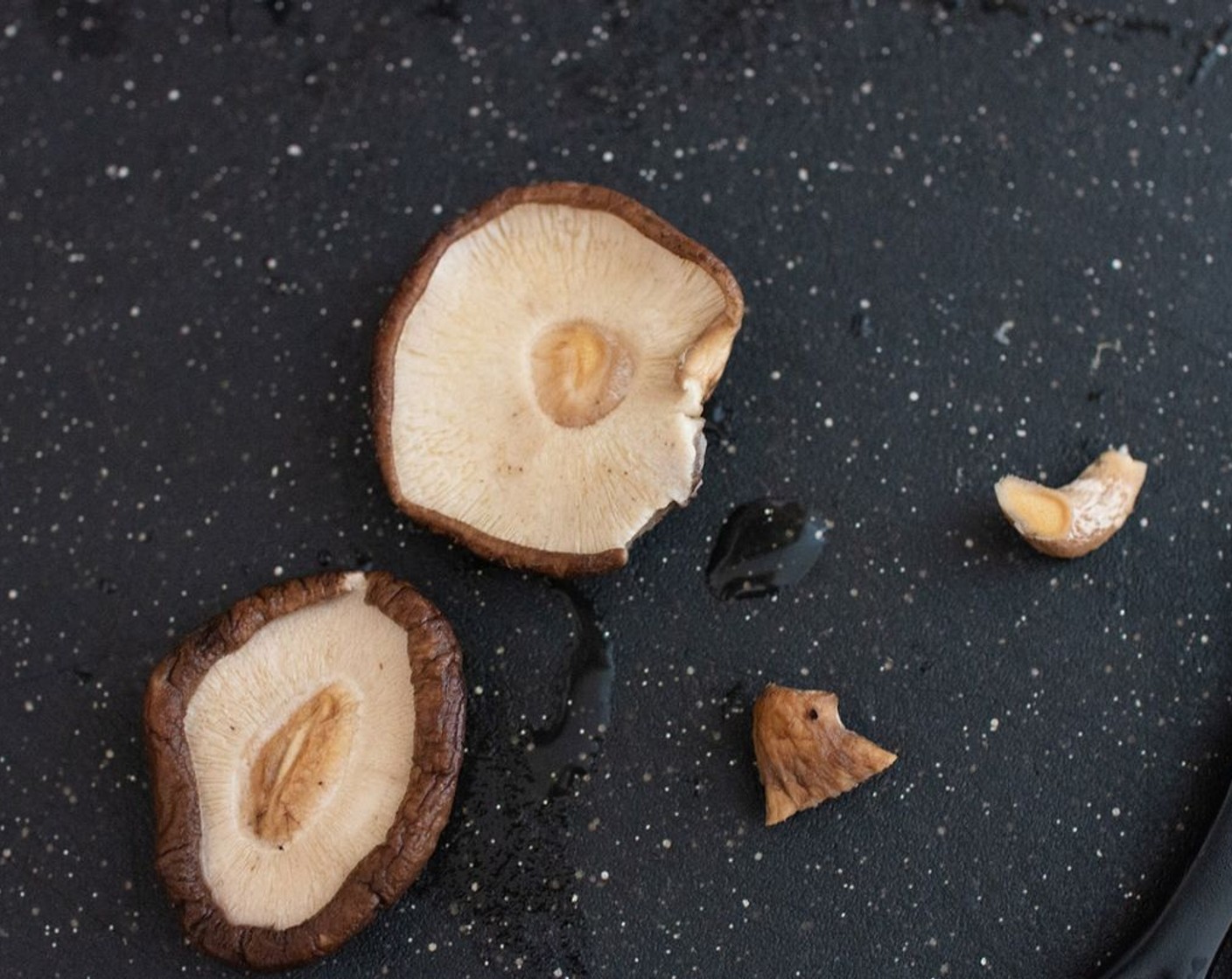 step 2 Remove the shiitake mushrooms from the water. Keep the water and set aside. Squeeze out the excess water from the shiitake mushrooms and trim the stems.