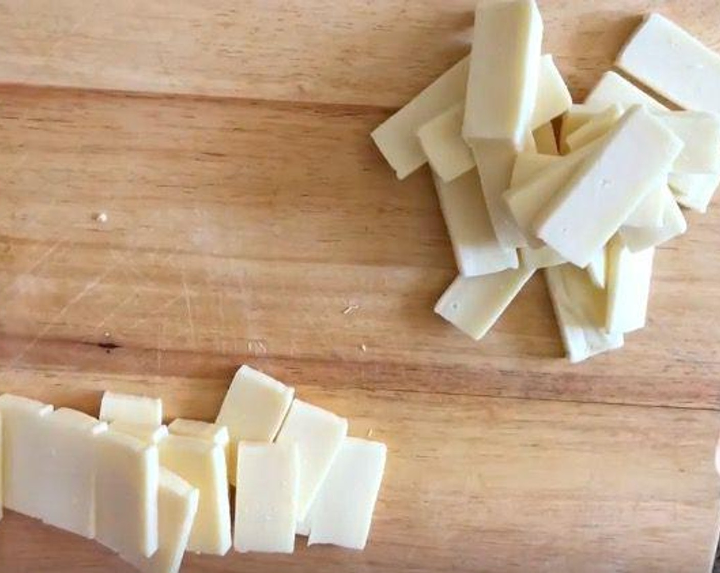 step 3 Cut Mozzarella Cheese (225 g) and Monterey Jack Cheese (225 g) cheese into 1/4-inch slices.