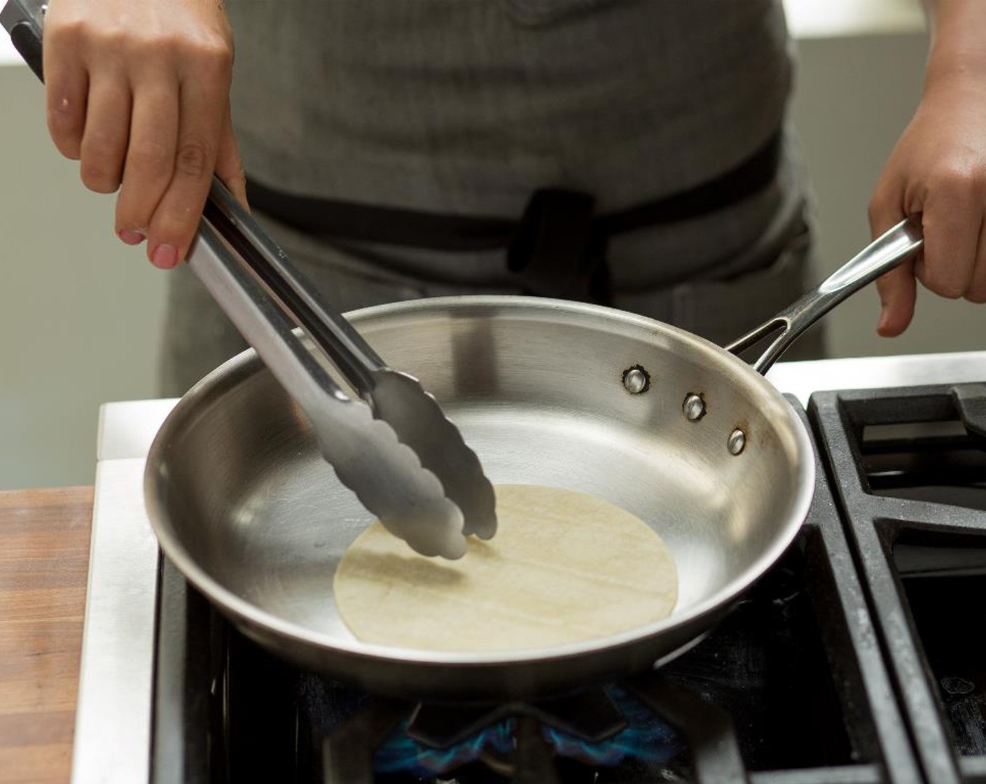 step 11 In a small sauté pan over high heat, warm the White Corn Tortillas (4) one at a time on both sides until heated through.