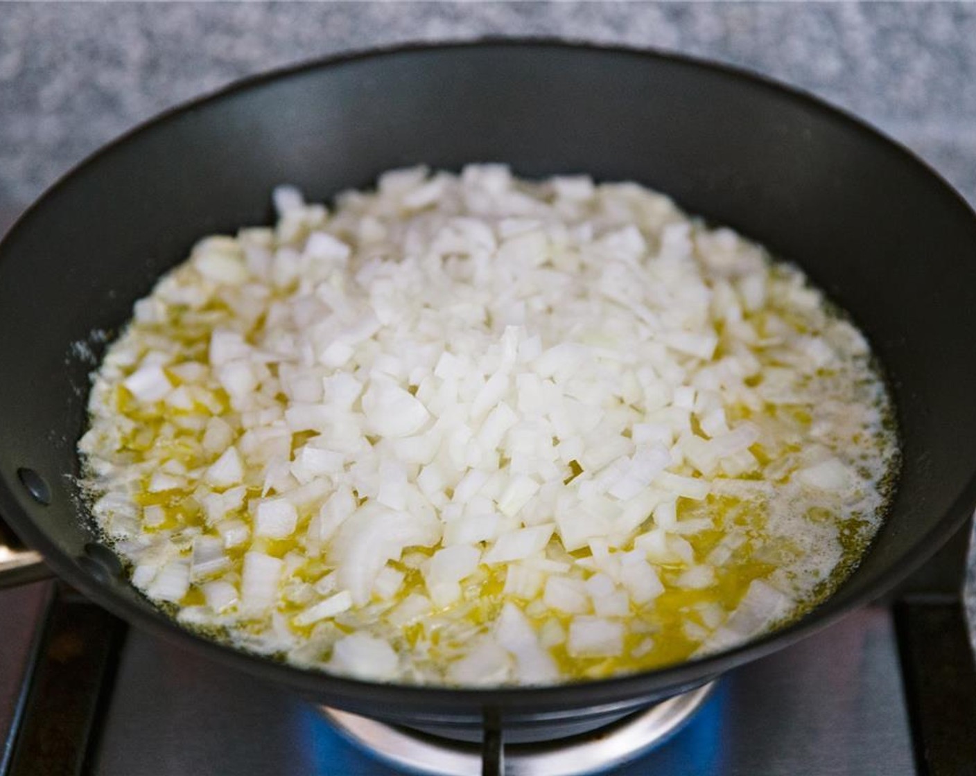 step 6 Add finely chopped onions to the skillet.