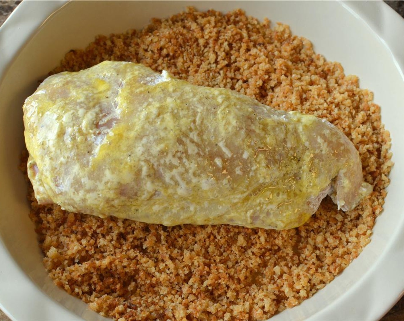 step 10 Working with one stuffed chicken breast at a time, coat the chicken lightly with flour, then dip the chicken in the egg and lastly in the bread crumbs. Make sure you're covering both sides.