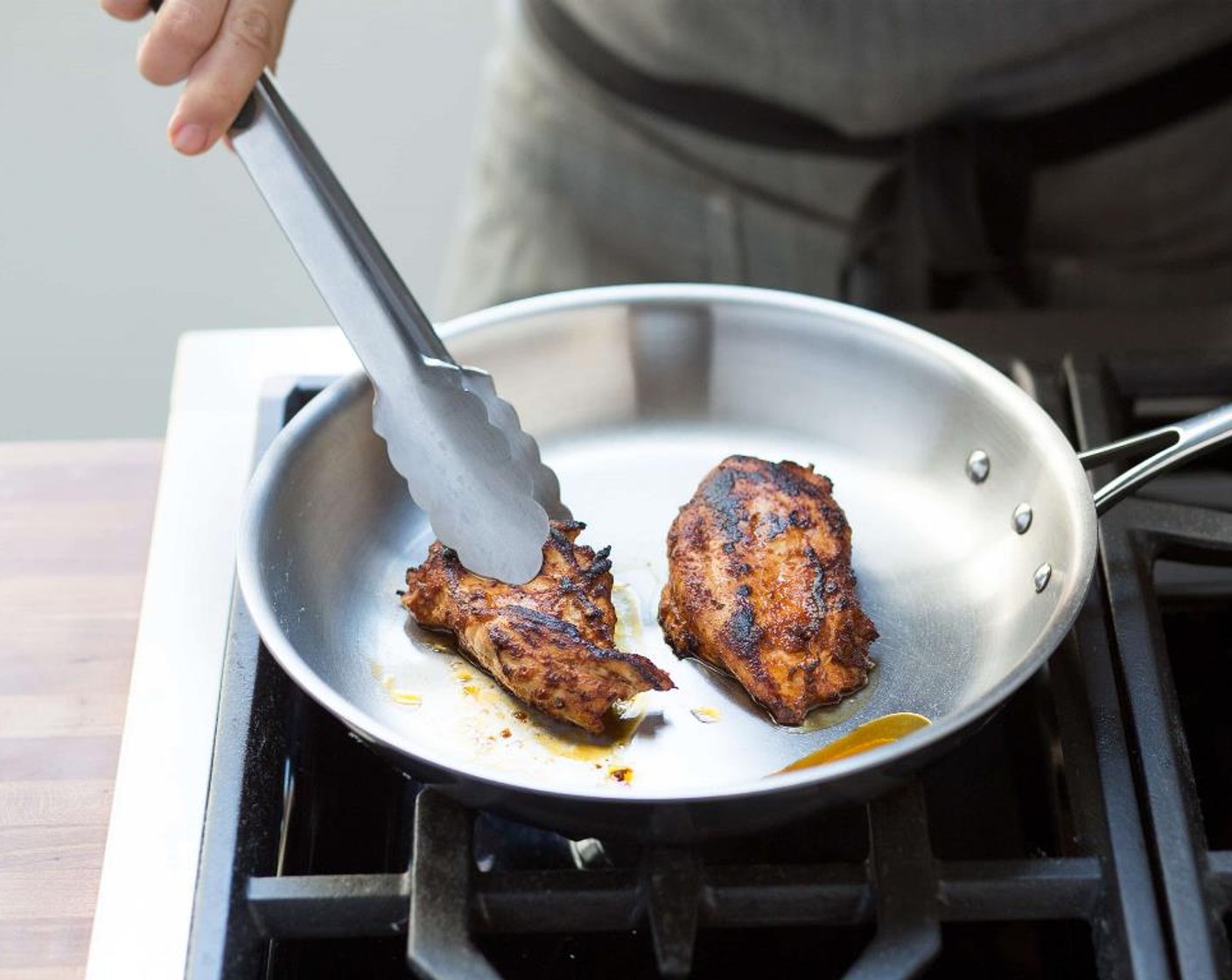 step 9 Heat a medium sauté pan over medium high heat with Olive Oil (1 Tbsp). When the oil is hot, add the chicken breasts and sear on each side for 4 minutes until golden brown and cooked through.