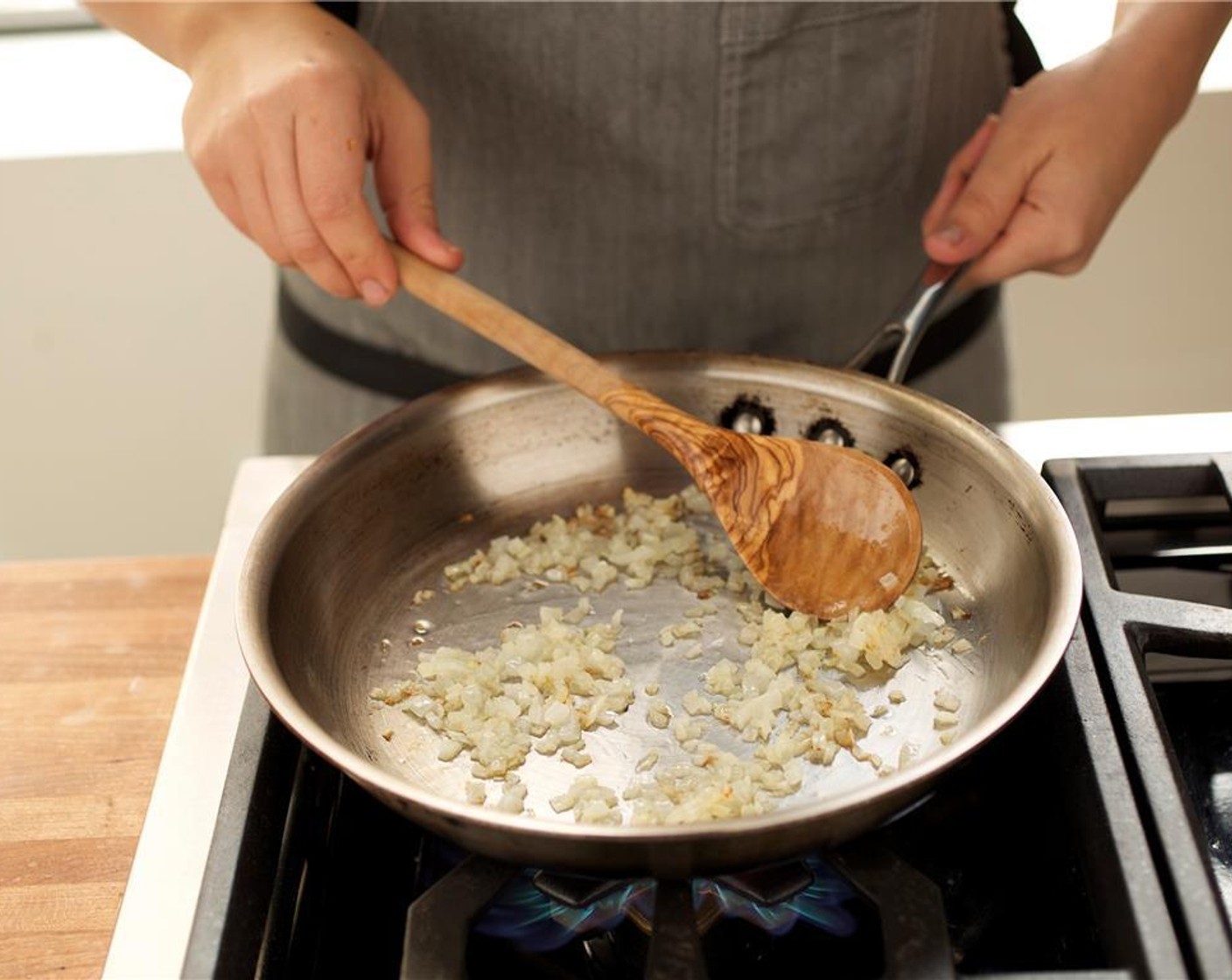 step 9 In the same pan used for the beef, heat Vegetable Oil (1 tsp) over medium-high heat and add the yellow onion. Stir occasionally, and cook until soft and caramelized, about five minutes.