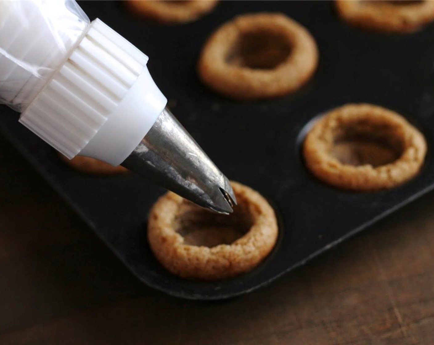 step 7 Spoon the filling mixture into a pastry decorating bag.  Pipe into tarts.