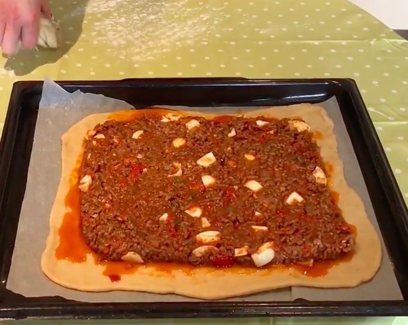 step 13 Roll out half the dough to make the base and put it in a tray and add the stuffing.