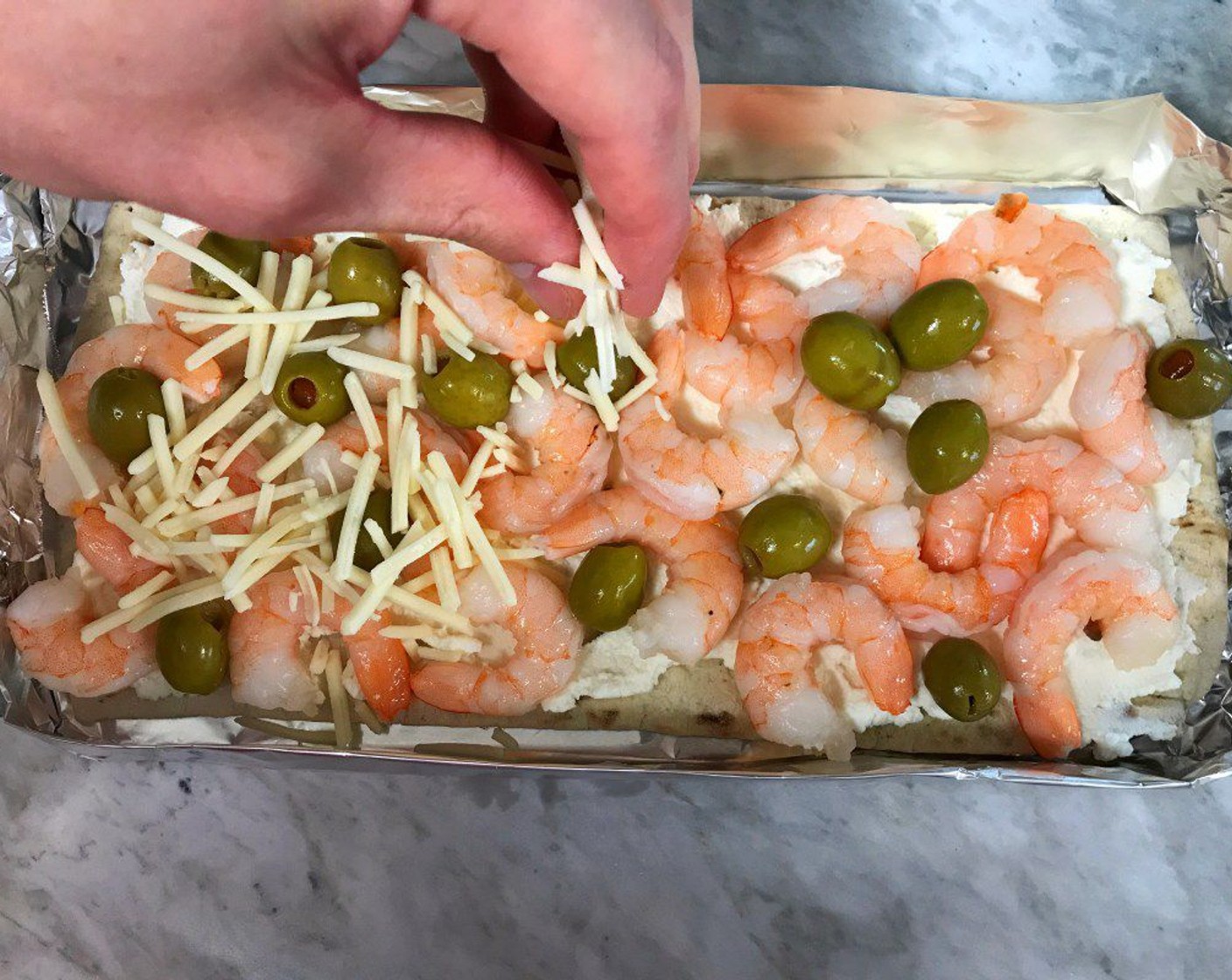 step 7 Top next with the shrimp and Olives (1/3 cup). Sprinkle with the Shredded Sharp Cheddar Cheese (3/4 cup).