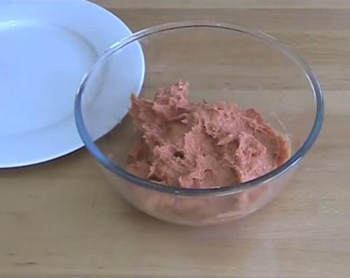 step 1 Into a mixing bowl, squeeze the meat out of the Sausages (8). Roll the meat into balls.