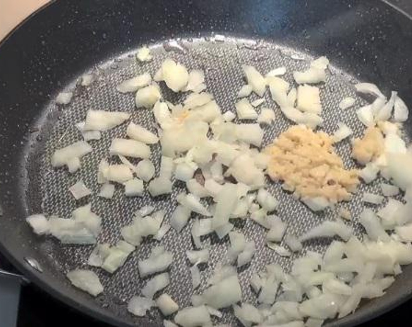 step 2 On the same frying pan, cook the Yellow Onion (1) and Garlic (2 cloves) until they are browned.