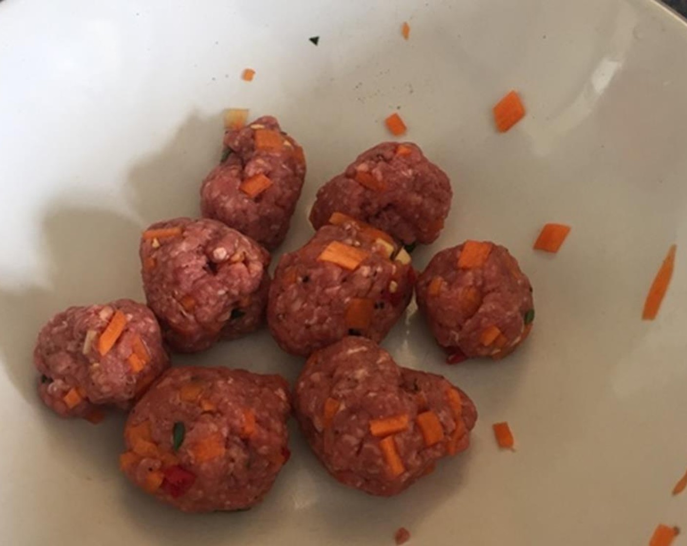 step 1 Put the Ground Beef (3.5 oz), Carrot (1/2), Fresh Ginger (1 piece), Red Bird's Eye Chili Pepper (1), Fresh Parsley (1 handful), and Kaffir Lime Leaf (1) in a bowl and then scrunch it all up to combine and shape into little meatballs.