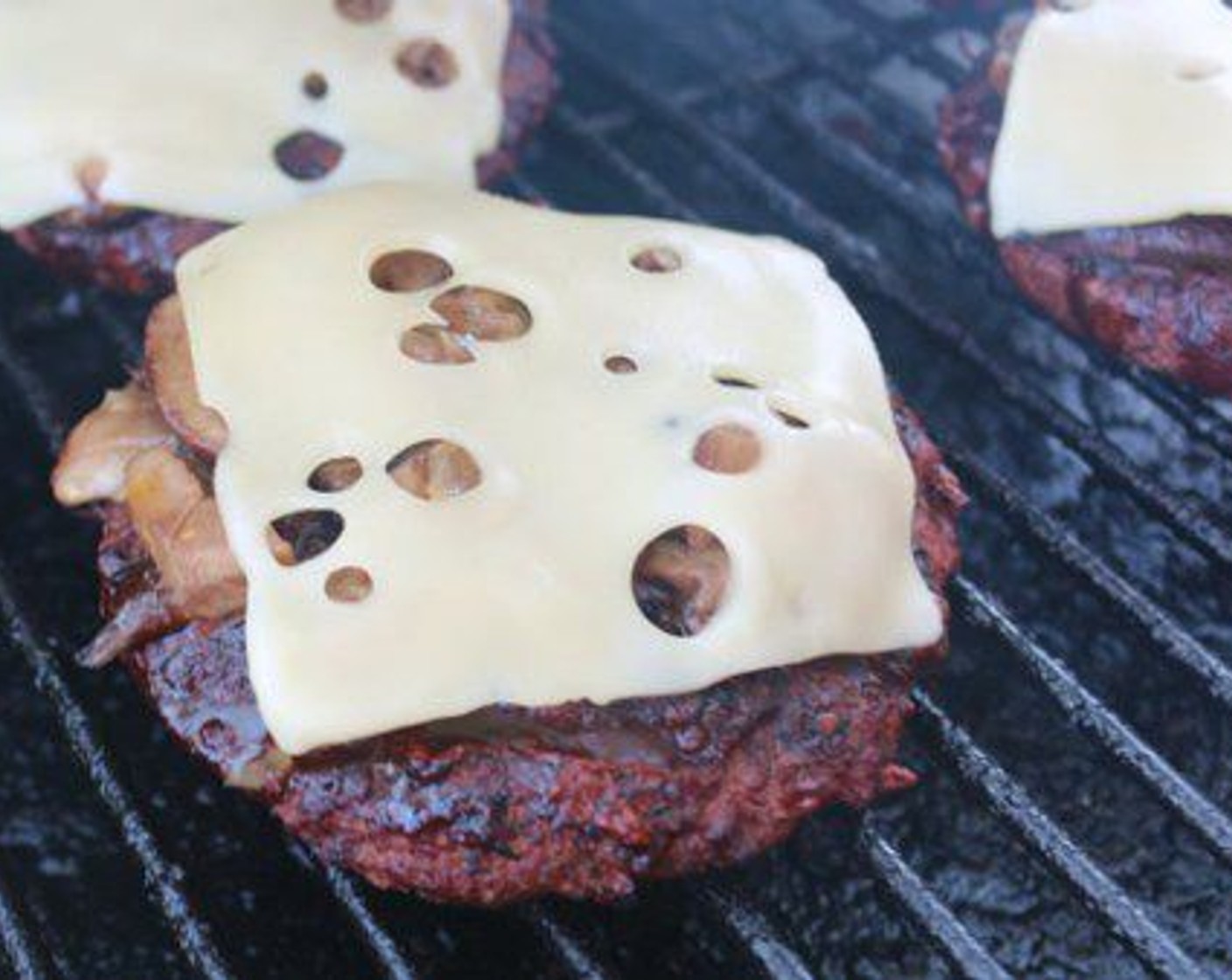 step 11 Top each burger with mushroom and onion mixture and a slice of Baby Swiss Cheese (6 slices), cook for 30-45 seconds to melt chee​se.
