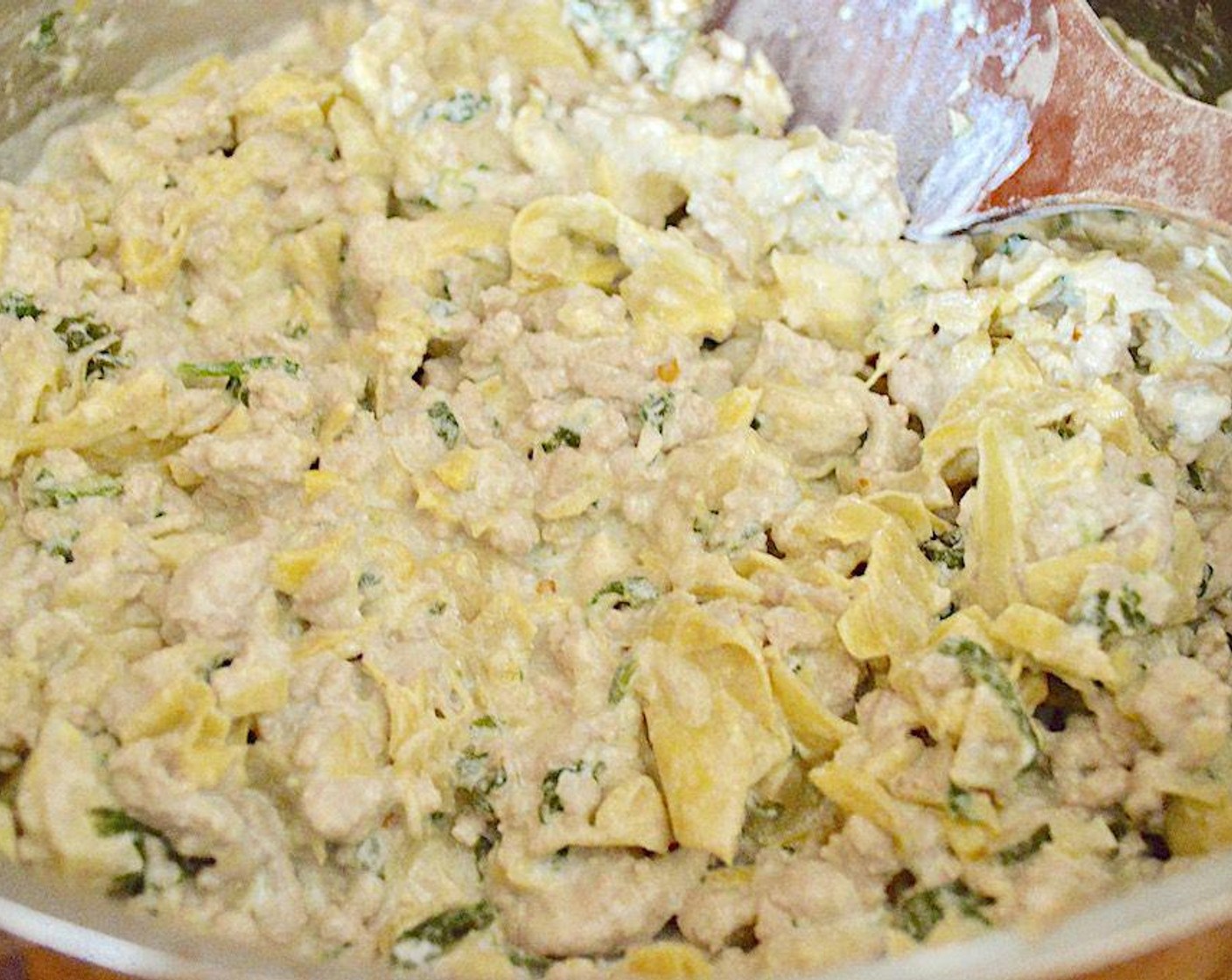 step 5 Once it is cooked, pour in the White Wine (1 Tbsp) and Chicken Stock (1 Tbsp). Let the whole mixture simmer until the liquid is gone for about 8 minutes. Finally, take the pan off of the heat and stir in the Ricotta Cheese (3/4 cup). Let the mixture cool while you get ready to bake.
