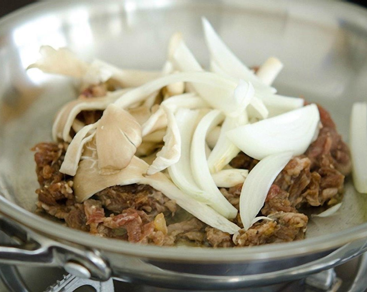 step 9 Heat a skillet over the medium-high heat, add some of the beef (you may need to cook 2-3 batches to cook it evenly), onion, and mushroom.