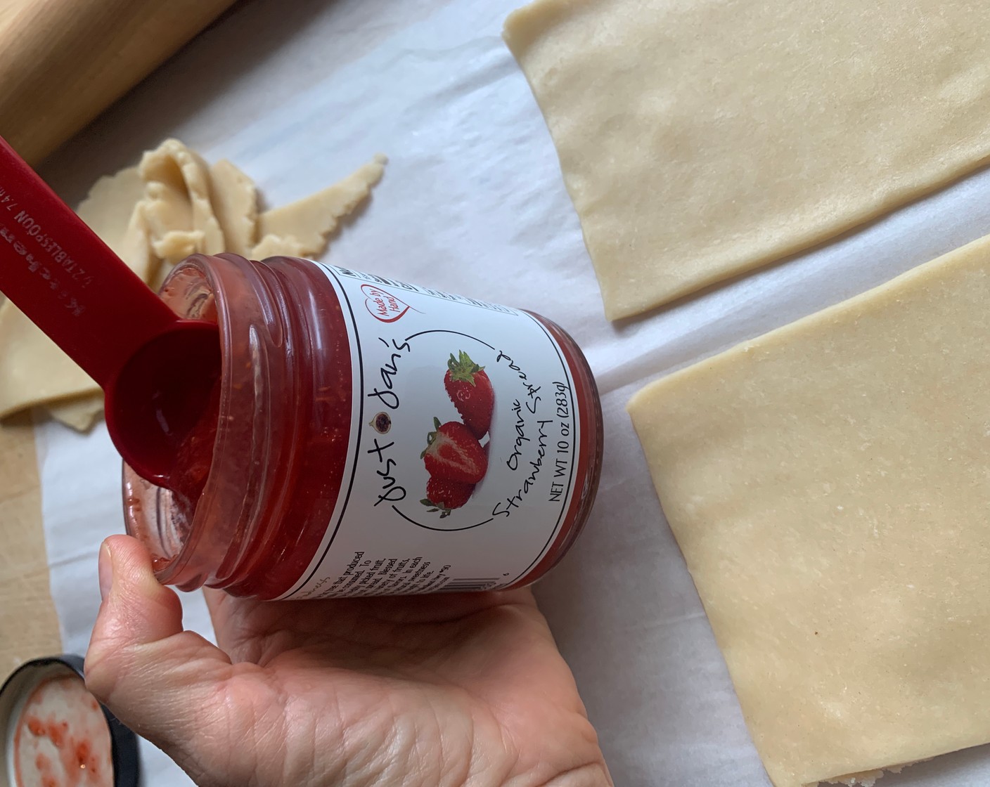 step 7 Spoon a generous tablespoon of Just Jan’s® Organic Strawberry Spread (1/2 cup) onto 8 of the pastry bottoms.
