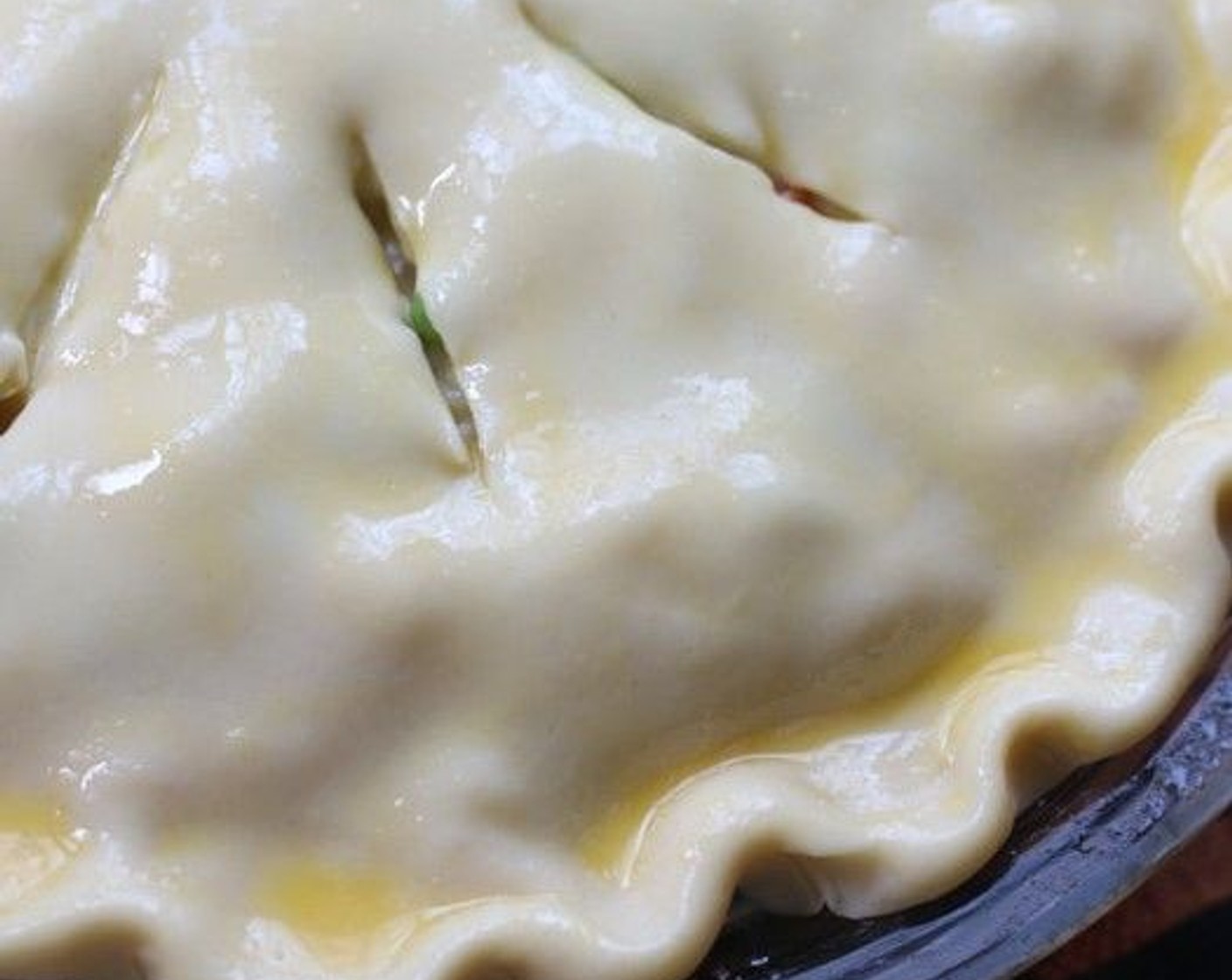 step 14 In a small bowl, beat the Egg (1) with a fork. Using a pastry brush, brush crust top and edges with beaten egg.