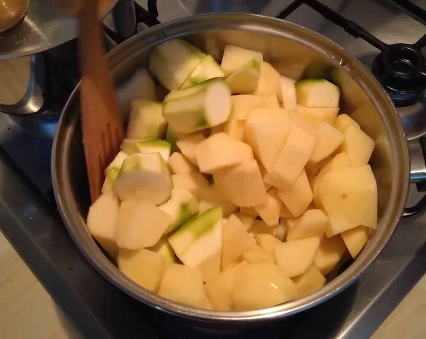 step 3 In another pan, add Olive Oil (as needed) and add the chopped garlic. When the oil gets hot add the onion, potatoes, and zucchini.