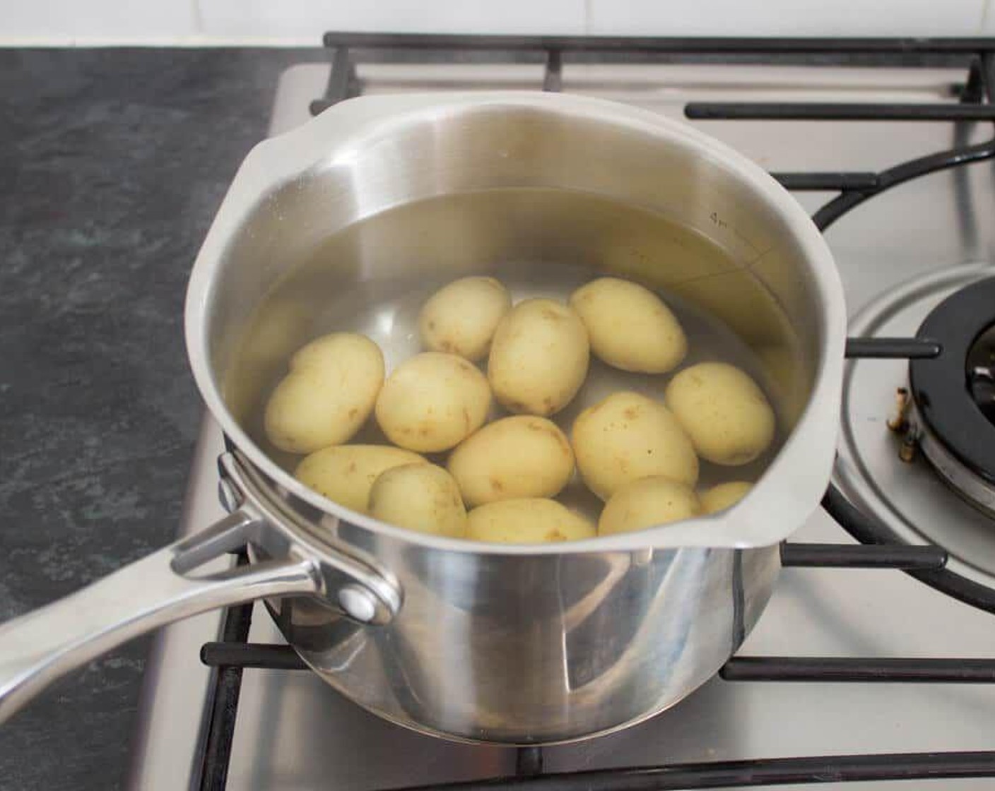 step 1 Bring a large pan of generously salted water to the boil. Add in the Baby Potatoes (16 oz) being careful not to splash yourself. Bring back up to the boil then cook for 15 minutes until starting to soften.