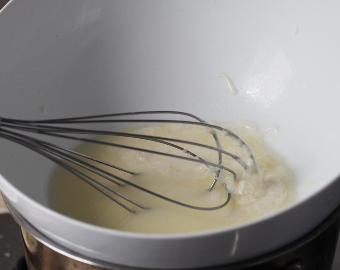 step 15 Heat the Dry White Wine (1/2 cup) up over a double boiler until it begins to steam. Gradually begin adding the cheese mixture, making sure to whisk in each handful at a time.