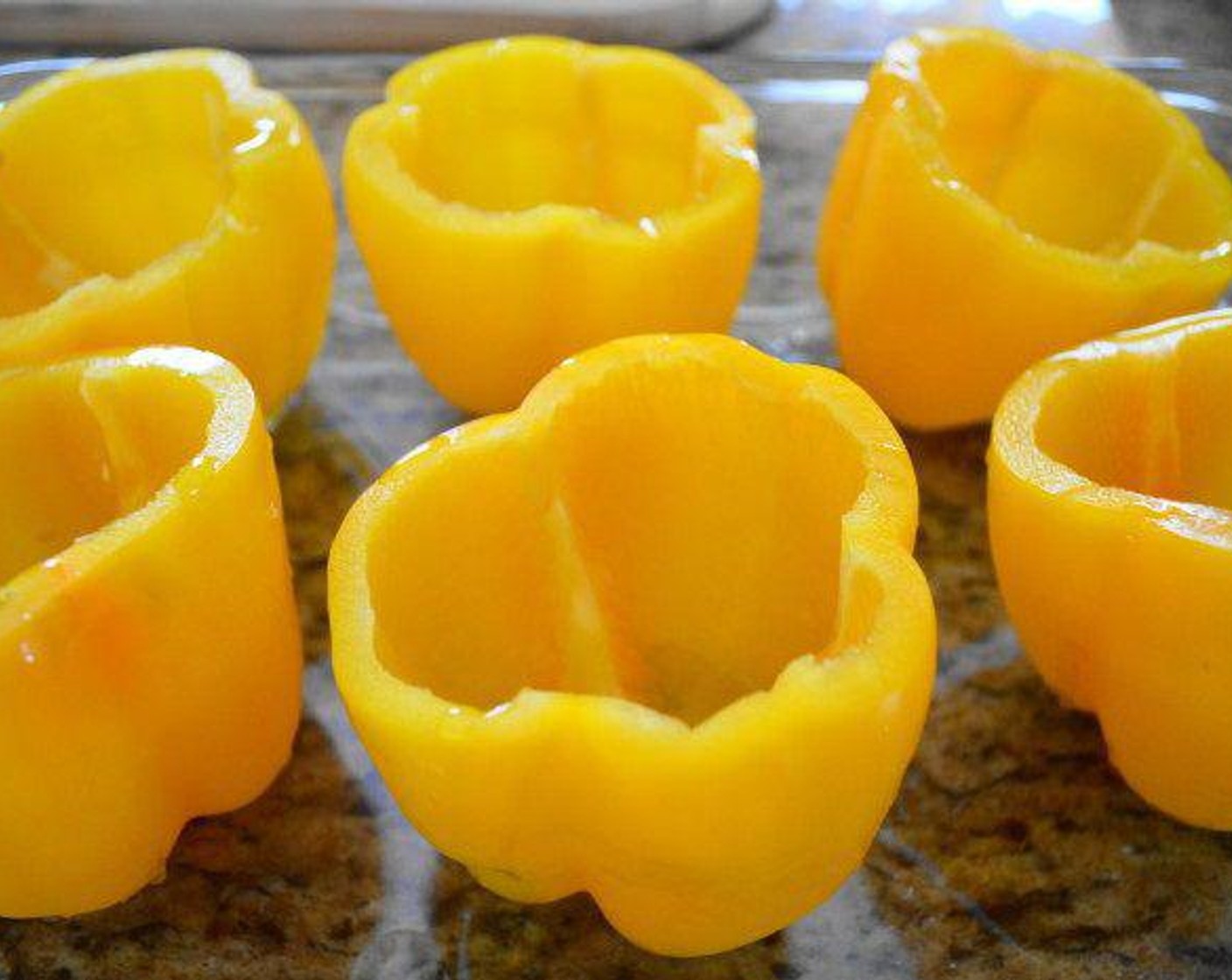 step 2 Prep your ingredients: Thoroughly wash the outside of the Yellow Bell Peppers (6) with cold water. Cut off the very tops and scoop out the seeds and membrane to have a nice, clean vessel for the filling.