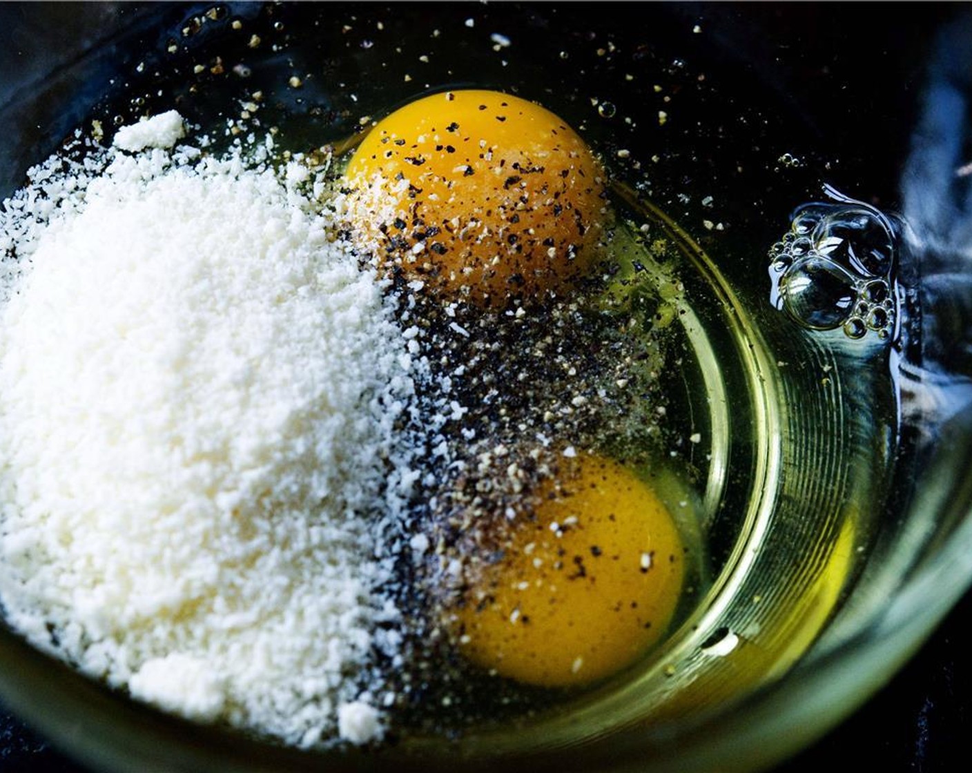 step 9 In a bowl, combine Farmhouse Eggs® Large Brown Eggs (2), Salt (1 tsp), Ground Black Pepper (1/2 tsp), and Parmesan Cheese (4 Tbsp).