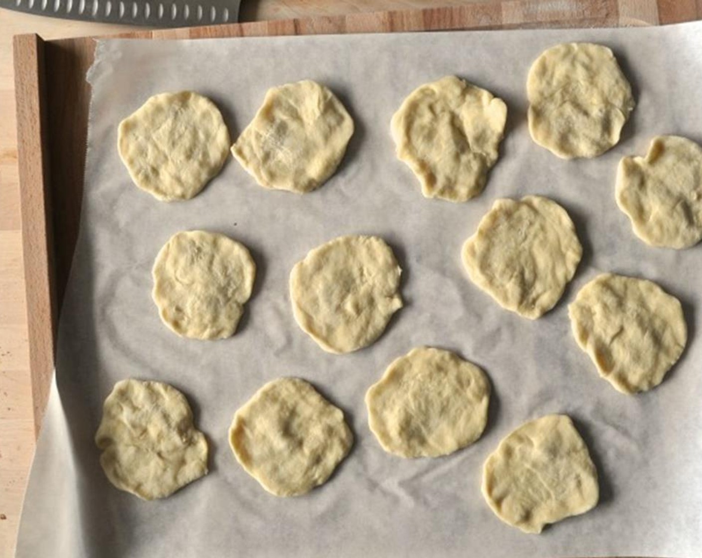 step 8 Divide dough into about 25 portions (about 30 grams each). Roll into ball and flatten into a disk 3-4 inches in diameter.