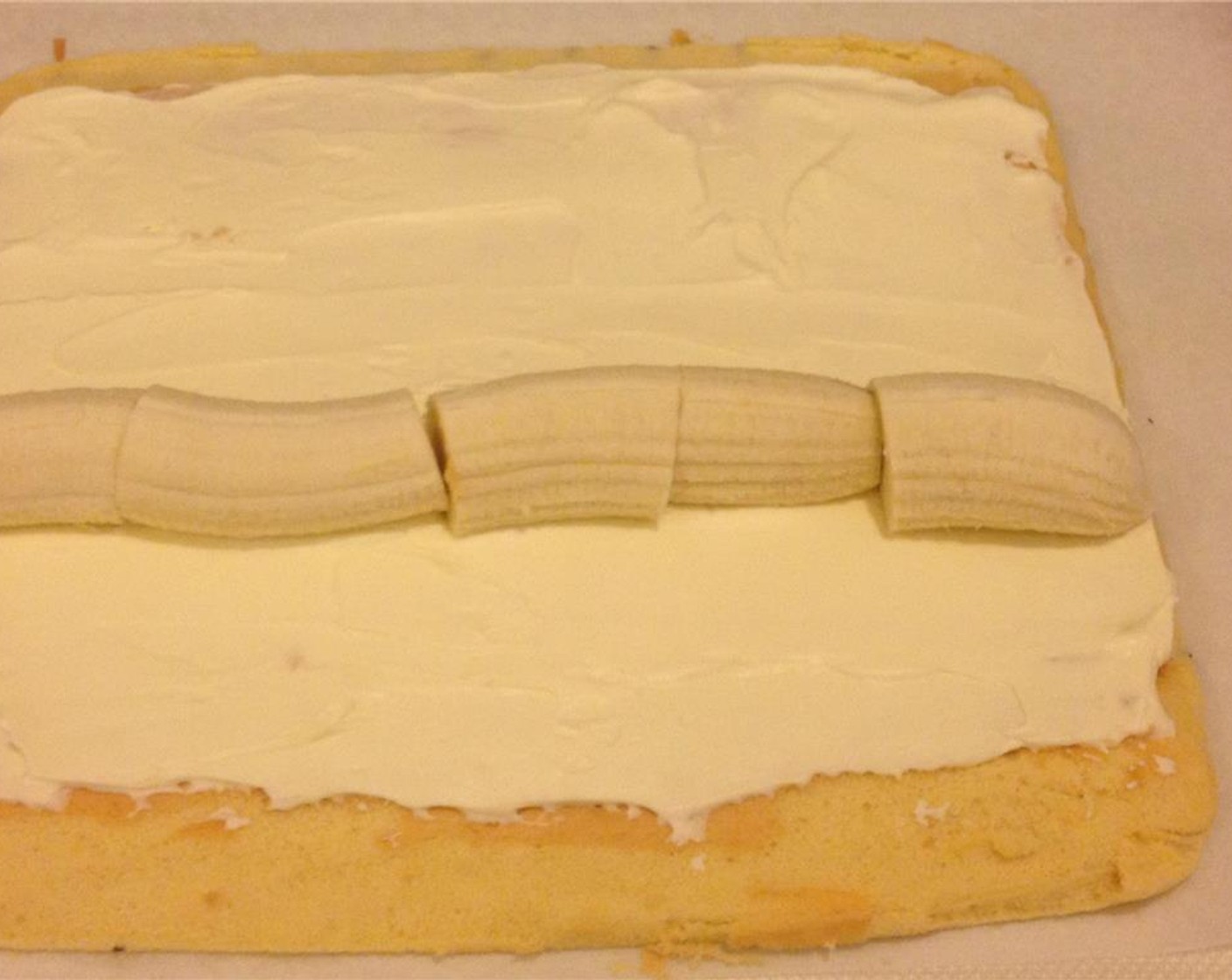 step 15 Slice the Bananas (2) into manageable pieces. Spread out the cream evenly and place the bananas in the middle.