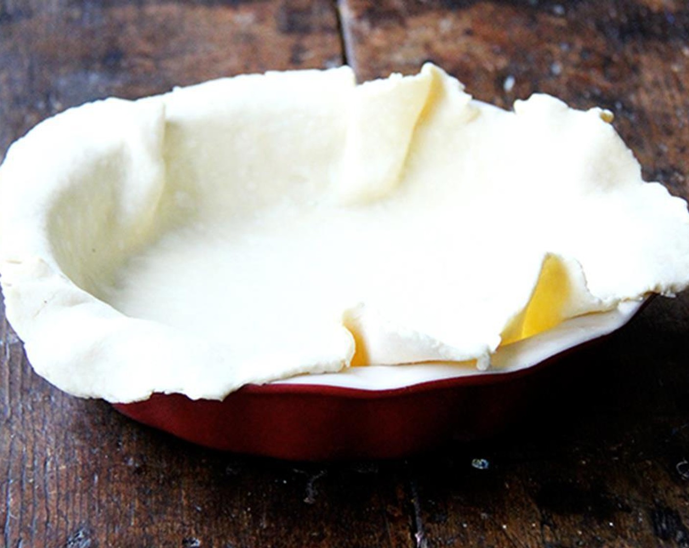 step 8 Meanwhile, blind bake the crust. Lay a sheet of parchment over pie dough, fill it with pie weights or dried beans, and bake in 400 degrees F (200 degrees C) oven for 15 minutes.