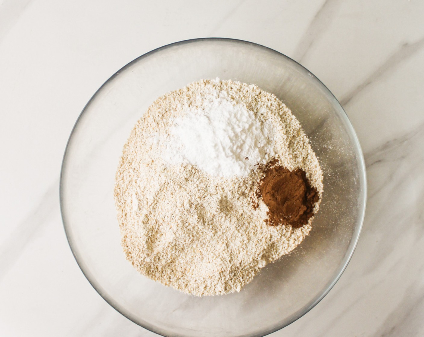 step 5 In another bowl, combine the Oat Flour (2 cups), Baking Soda (1 tsp), Baking Powder (1 Tbsp), and Simply Organic Cinnamon, Ground (1 tsp). Stir to combine.