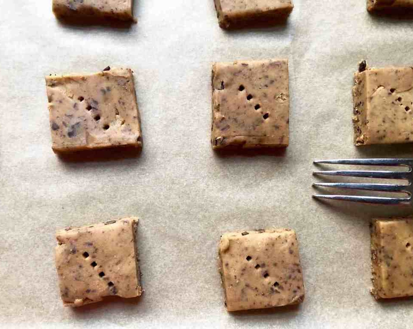 step 10 Transfer the squares to the baking sheets and carefully prick each one with a fork, gently pushing the tines through the cookies until they hit the sheet.