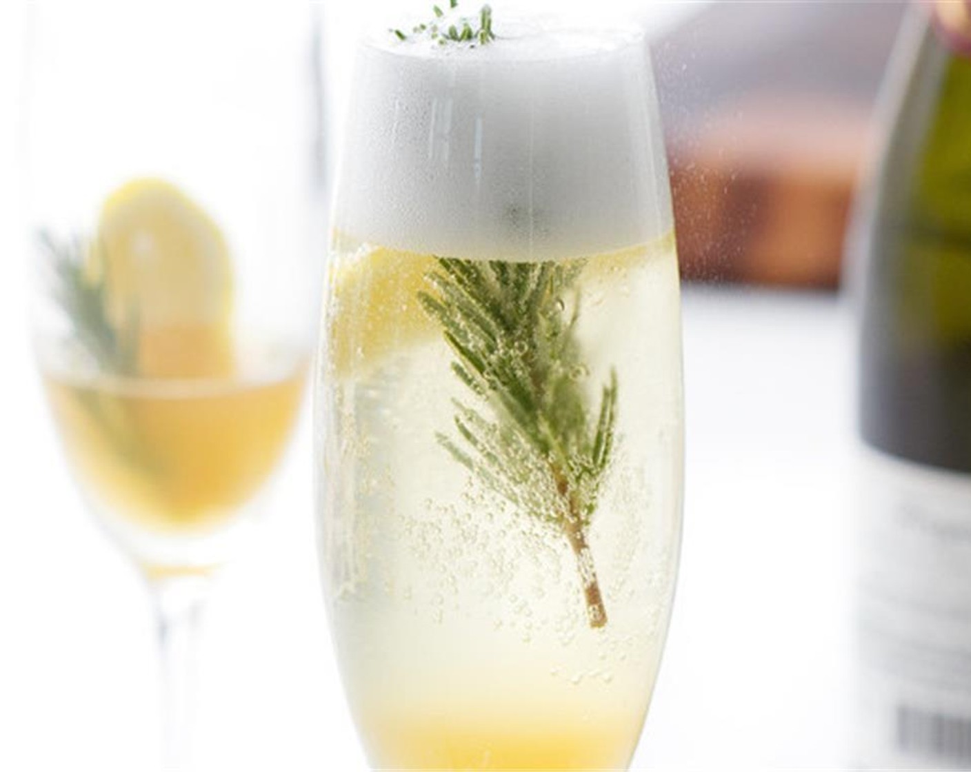 step 2 Pour strained liquid into 2 champagne glasses. Top each with Champagne (to taste), and serve with a Fresh Rosemary (1 sprig) as a garnish.