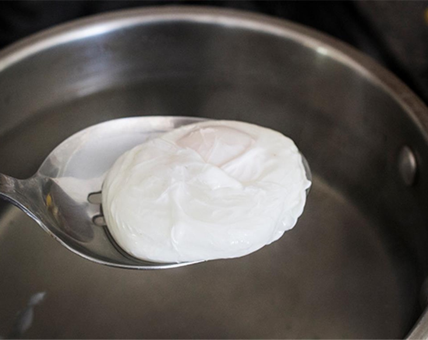 step 11 Do this again with the second egg.  Cover the pan with a lid and let it cook for 3 minutes (no peeking!)  Once cooked, use a slotted spoon to gently lift the eggs out of the water. Transfer to a paper towel to drain.