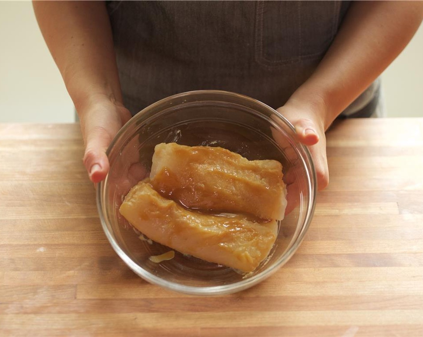 step 4 Pat dry Cod Fillets (2) with paper towels. Place fillets on a sheet pan lined with parchment paper and brush marinade over the fillets. Let marinate for 15 minutes.