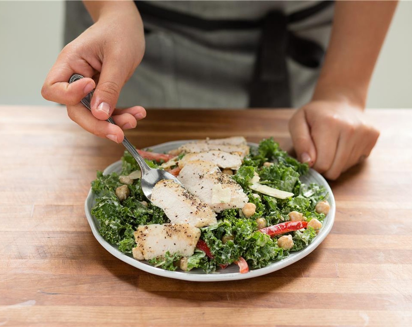 step 16 In the center of two plates, place the chicken kale Caesar salad.